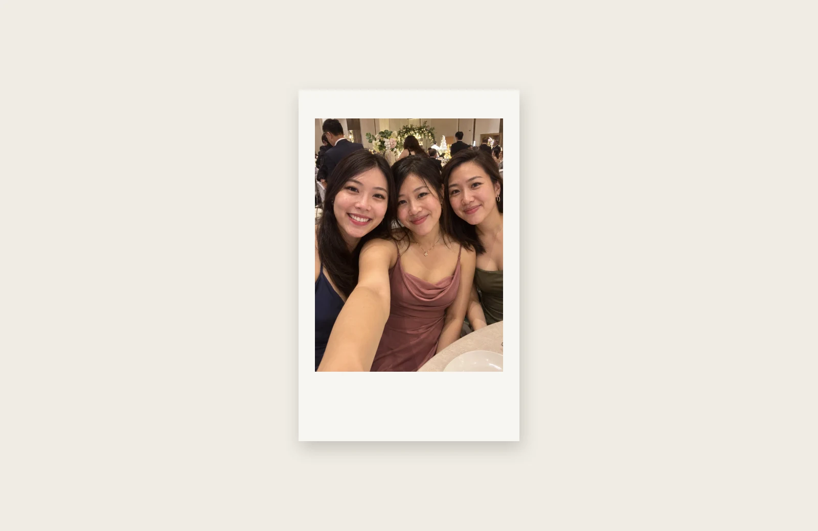 An illustration of an Instax Mini print showing the same three friends in colour with a white border.